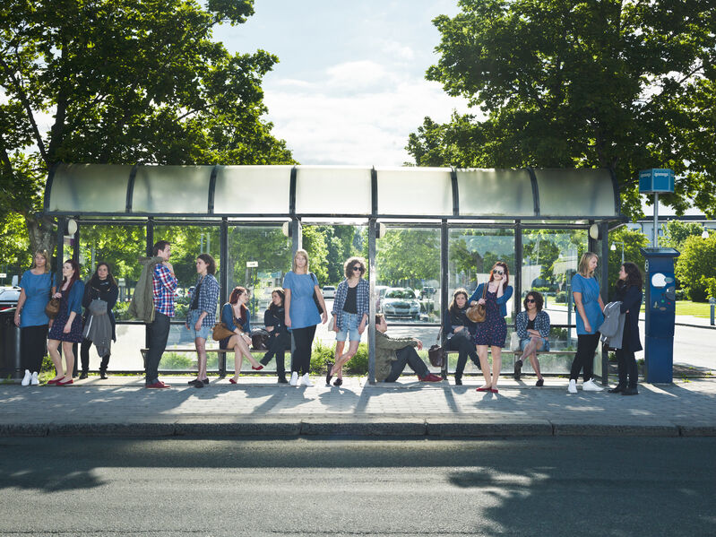 Large group of people waiting on the bus