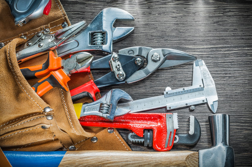 Composition of leather tool belt with construction tooling on wooden board