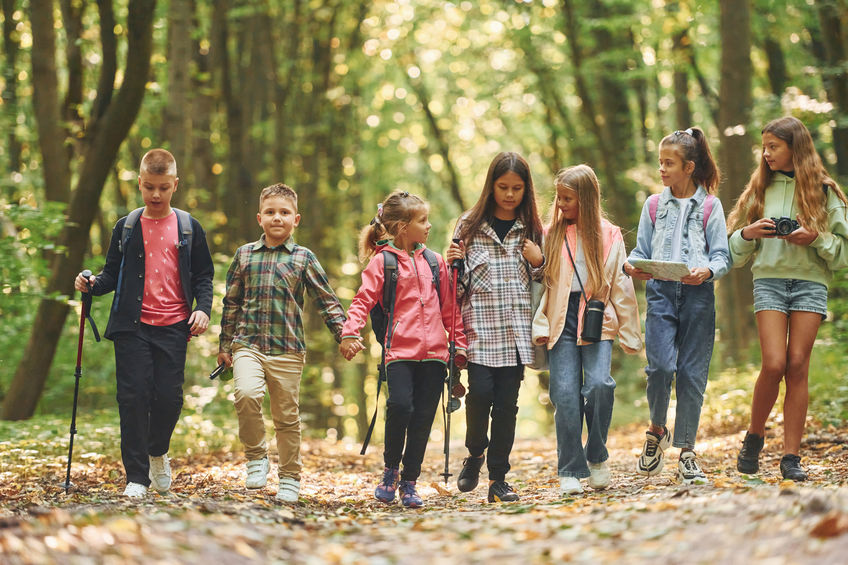 Kids having a walk outdoors in fall ,daytime together